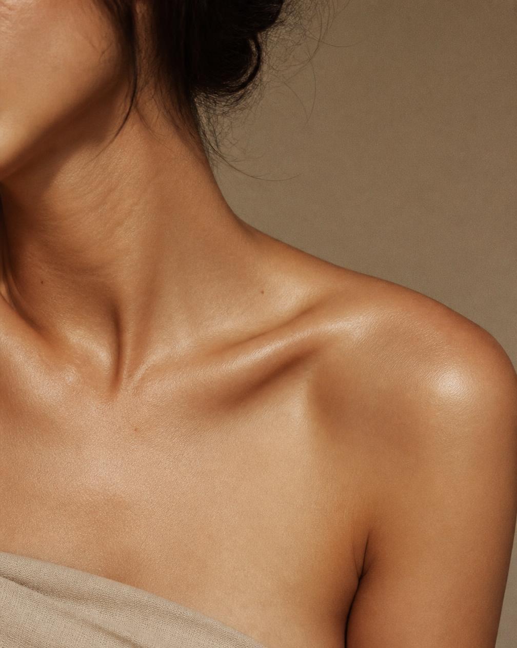 Editorial photograph of smooth skin on shoulder and collarbone